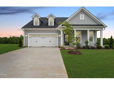 Gray house with white trim, two-car garage, and landscaped lawn at 40 Eagle Crest Ct # Clayton Low Country, Lillington, NC 27546