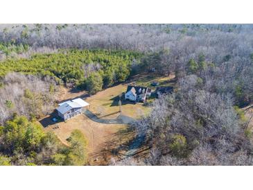 Aerial view of house, detached garage, and expansive wooded lot at 4340 Bellemont Mt Hermon Rd Rd, Burlington, NC 27215