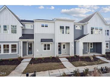 Gray and white exterior of townhouses with front porches at 602 Hillfarm Dr, Wake Forest, NC 27587