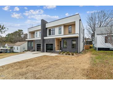 Modern two-story home with dark brick and white accents, two-car garage at 715 1/2 Van Buren Rd, Raleigh, NC 27604