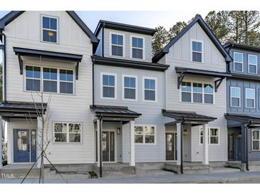 Charming townhomes feature modern exteriors with covered entrances and beautiful architectural details at 8610 Brushfoot Way # 106, Raleigh, NC 27616