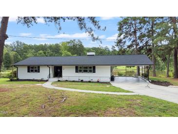 Newly renovated ranch home with carport and pond view at 889 Burlington Rd, Roxboro, NC 27573