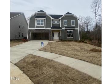 Charming two-story home with stone accents, attached garage, and front yard at 9349 Kitchin Farms Way # 463, Wake Forest, NC 27587