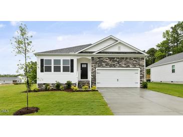 Charming single-Gathering home with stone accents, black shutters, a two-car garage, and manicured lawn at 155 Scenic Rock Dr, Youngsville, NC 27596