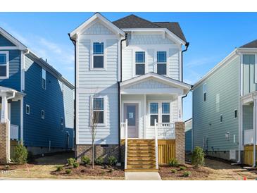 Two-story light blue house with white trim and wooden steps at 1549 Piney Fls Dr, Wendell, NC 27591