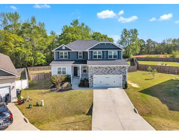Two-story home featuring gray and white siding, a gray roof, and a two-car garage at 298 Hannah Yam Ln, Benson, NC 27504