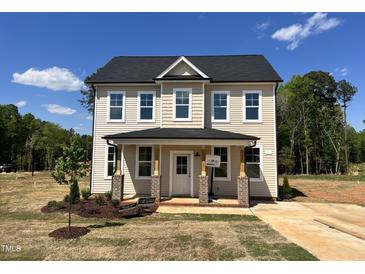 Two-story home boasts a charming front porch and a classic design in a picturesque setting at 302 Longbow Dr, Middlesex, NC 27557