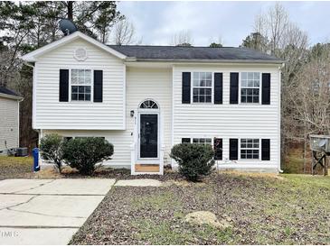 Two-story white house with black windows, landscaping, and a driveway at 311 Gladstone Dr, Durham, NC 27703