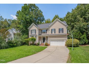 Charming two-story home featuring a well-maintained yard, two car garage, and lush landscaping at 106 Dairy Ct, Chapel Hill, NC 27516