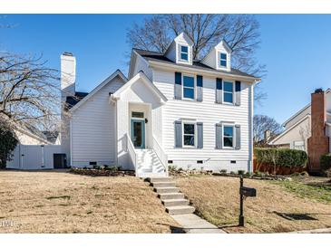 Charming two-story home with white siding, gray shutters, and a landscaped lawn at 110 Ethans Glenn Ct, Cary, NC 27513