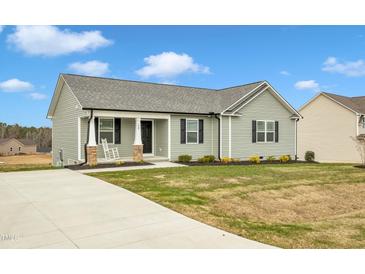 Single-story house with gray siding, a porch, and a driveway at 120 Starry Sky Dr, Benson, NC 27504