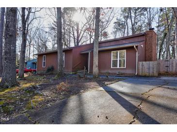 Charming, well-maintained home with a classic brick chimney and lovely front yard at 1225 Kilmory Dr, Cary, NC 27511