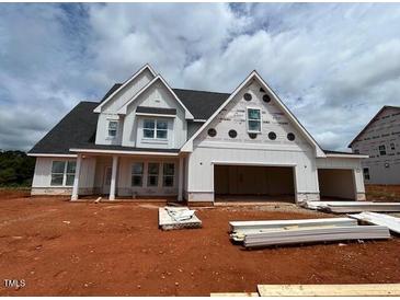 New two-story home features a white exterior, dark roof, and an attached two-car garage at 132 Tennyson Dr, Garner, NC 27529