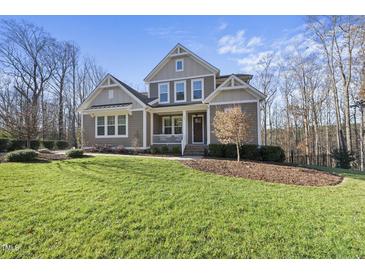 Two-story house with gray siding, white trim, and a front porch at 148 Hidden Creek Ct, Pittsboro, NC 27312