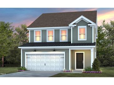 Two-story house with gray siding, white garage door, and landscaping at 2790 Farmhouse Dr, Apex, NC 27502