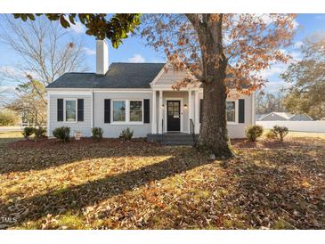 Charming ranch home with gray exterior, landscaping, and mature trees at 1200 Rogers Rd, Graham, NC 27253