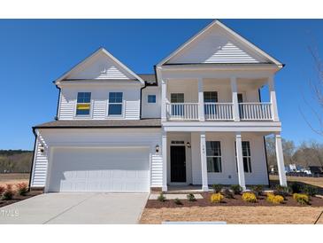 Charming two-story home featuring a welcoming front porch and attached two-car garage at 143 Steppe Way, Garner, NC 27529