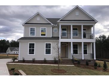 Two-story house with a front porch and landscaped yard at 143 Steppe Way, Garner, NC 27529