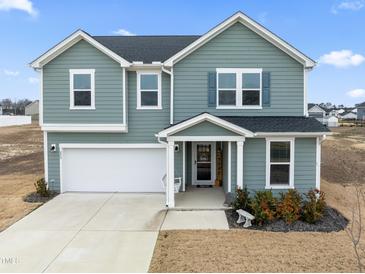 Two-story house, gray siding, attached garage, and a welcoming porch at 233 John Stark Dr, Fuquay Varina, NC 27526