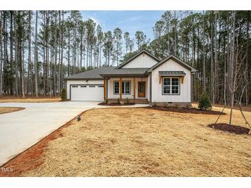 Newly built home with white siding, gray accents, and a two-car garage at 4120 Emily Ln, Oxford, NC 27565