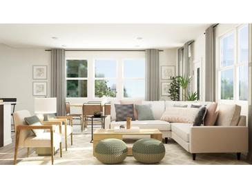 Bright living room featuring a sectional sofa, coffee table, and large windows at 1888 Sweet Gardenia Way, Apex, NC 27502