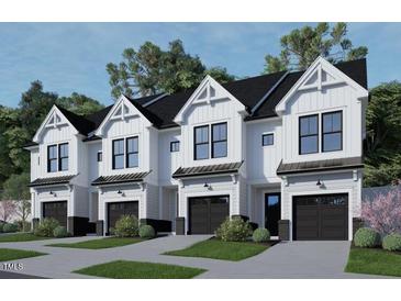 Four modern townhouses with attached garages and landscaping at 4075 Elk Creek Ln # 9, Raleigh, NC 27612