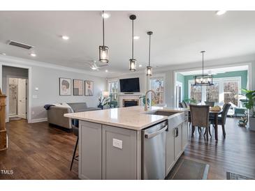 Modern kitchen with large island, stainless steel appliances, and white cabinetry at 88 Capewood Ct, Garner, NC 27529