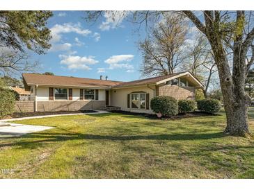 Ranch style home with mature landscaping and a spacious yard at 103 Marion Dr, Erwin, NC 28339
