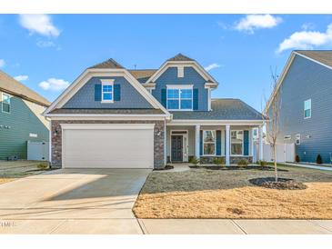 Two-story house with gray siding, stone accents, and a two-car garage at 1039 Brockton Dr, Mebane, NC 27302
