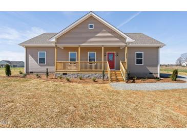 Charming single-story home with a covered front porch and a bright red front door at 1820 Johnson Rd, Burlington, NC 27217
