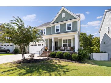Two-story craftsman home with front porch and landscaped lawn at 296 Two Creeks Lp, Chapel Hill, NC 27517