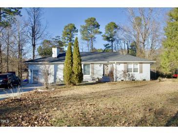 White single story home with mature trees and landscaping at 101 Oakmont Ave, Durham, NC 27713