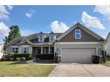 Charming single-story home with manicured lawn and a two-car garage on a sunny day at 108 Kaspurr Dr, Garner, NC 27529