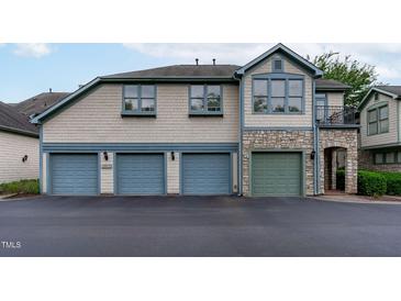 Three-car garage, stone accents, and a charming front entrance at 201 Presque Isle Ln, Chapel Hill, NC 27514