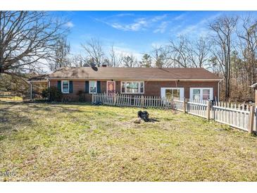 Brick ranch home with a spacious yard, detached garage, and a separate shed at 2540 Mayo Lake Rd, Roxboro, NC 27574