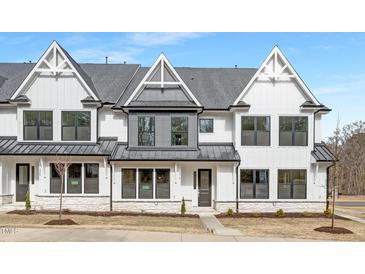New construction townhome with modern farmhouse exterior, gray roof, and stone accents at 316 Church St, Morrisville, NC 27560