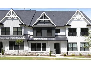 Charming modern farmhouse-style townhome featuring black window frames and a metal roof at 316 Church St, Morrisville, NC 27560