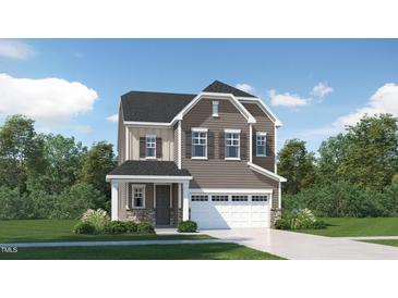 Two-story house with gray siding, white garage door, and stone accents at 1212 Coral Cay Bnd, Wake Forest, NC 27587