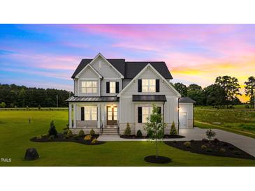 Gorgeous two-story home with a manicured lawn and craftsman-style architecture at 190 Broadleaf Ln, Youngsville, NC 27596