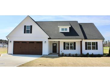 Charming new construction with a two-car garage and manicured front lawn at 24 Surles Landing Way, Benson, NC 27504