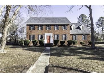 Brick two-story house with a red door and landscaped lawn at 805 Joshua Clay Dr, Rocky Mount, NC 27803