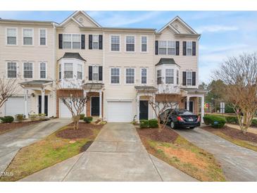 Three-story townhouses with attached garages and landscaping at 1673 Snowmass Way, Durham, NC 27713