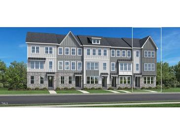 Three-story townhouses with gray siding and white trim at 522 Billingshurst Way, Knightdale, NC 27545