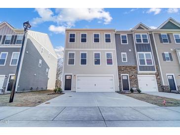 Two-story townhome with attached garage and neutral siding at 871 Parc Townes Dr # 1, Wendell, NC 27591