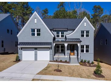 Two-story house with gray siding, two-car garage, and landscaping at 126 Sanderway Dr, Chapel Hill, NC 27516