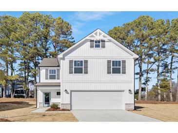 Charming two-story home showcasing white siding, gray shutters, and a spacious two-car garage at 216 Horseshoe Pl # 25, Angier, NC 27501