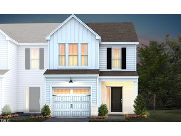 Two-story home with white siding, gray roof, and a two-car garage at 242 Broomside Ave, Raleigh, NC 27603