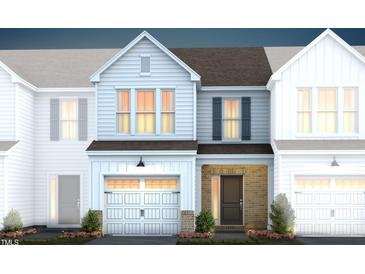 Two-story townhome with light-grey siding, dark-grey roof, and a brick entryway at 246 Broomside Ave, Raleigh, NC 27603
