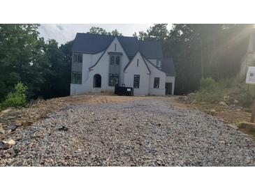 New construction two-story home with modern design elements and a wooded backdrop at 286 W Beech Slope Ct, Chapel Hill, NC 27517