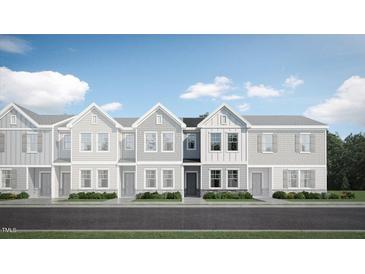 Attractive exterior of a townhome with gray siding and stone accents at 1235 Willow Tree Way, Graham, NC 27253